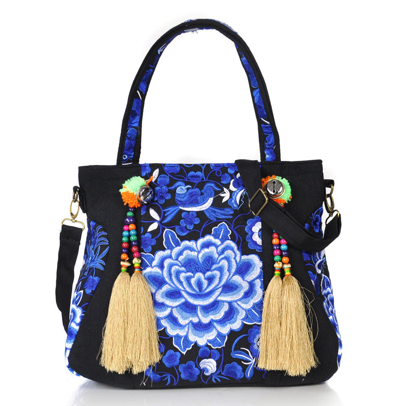 Ethnic Embroidery Canvas Shoulder Bag for Women featuring floral patterns and tassel accents, made from durable canvas with a spacious interior.