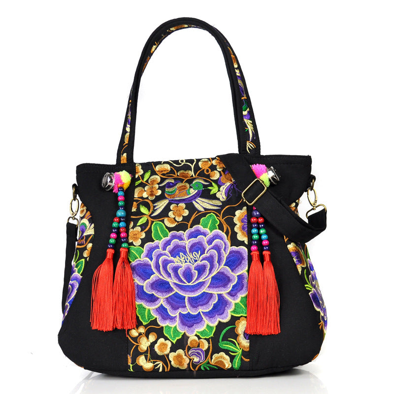 Ethnic Embroidery Canvas Shoulder Bag for Women featuring floral patterns and tassel accents, made from durable canvas with a spacious interior.
