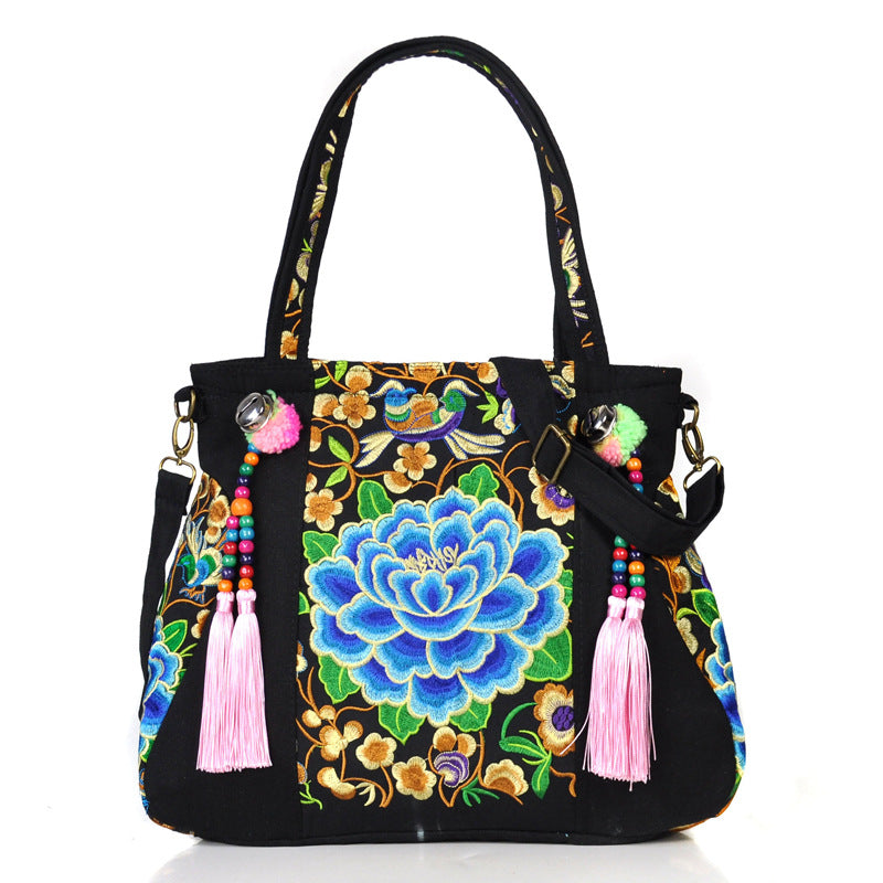 Ethnic Embroidery Canvas Shoulder Bag for Women featuring floral patterns and tassel accents, made from durable canvas with a spacious interior.