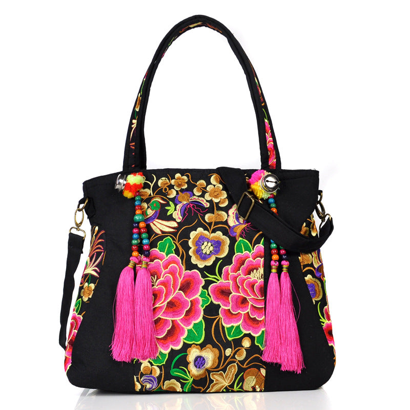 Ethnic Embroidery Canvas Shoulder Bag for Women featuring floral patterns and tassel accents, made from durable canvas with a spacious interior.