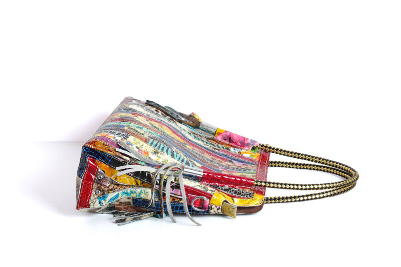 European and American Lady's Portable Striped Handbag featuring a stylish striped design, tassel detail, and durable cowhide material.