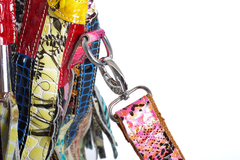 European and American Lady's Portable Striped Handbag featuring a stylish striped design, tassel detail, and durable cowhide material.