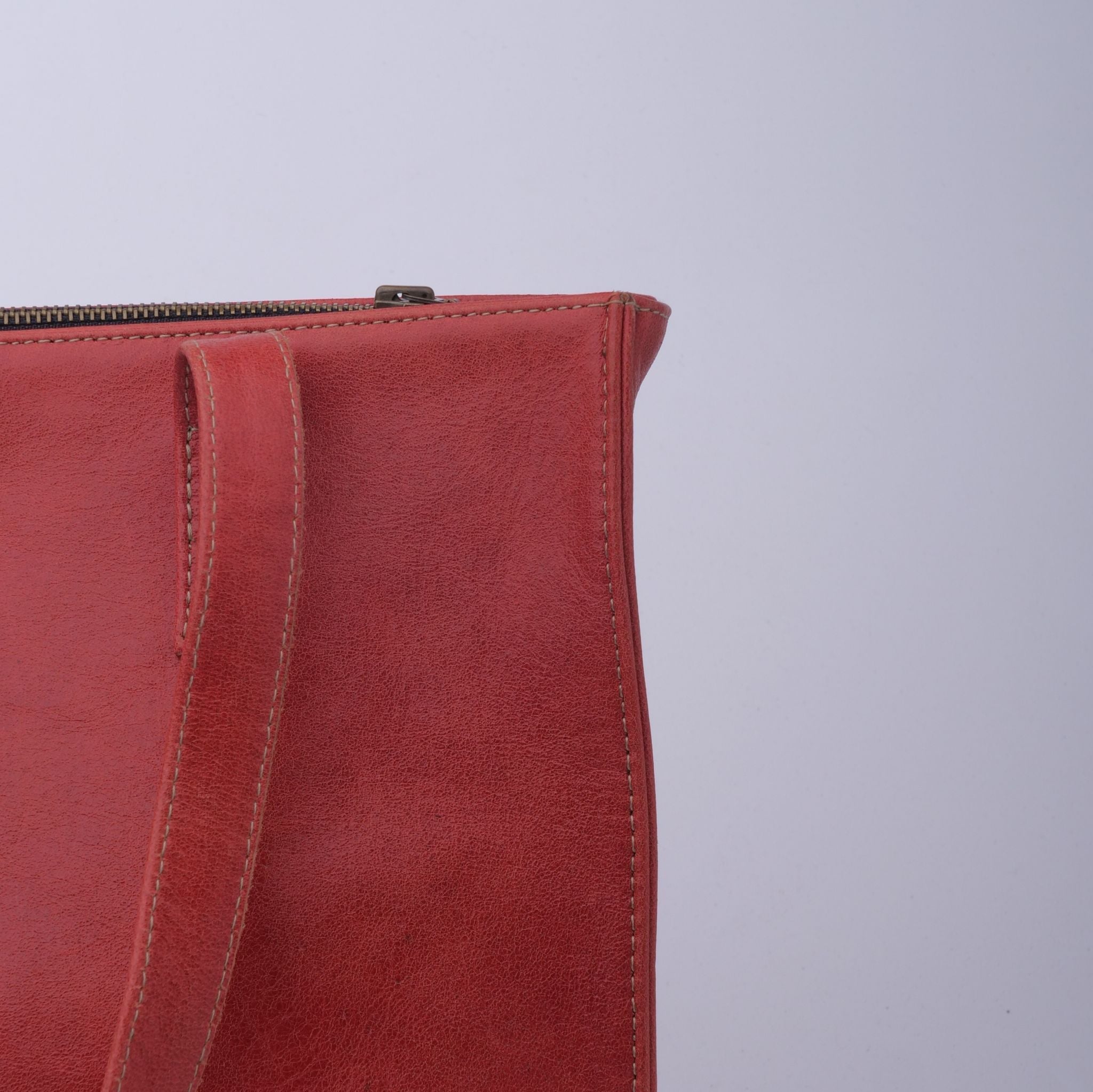 Everyday Women's Leather Zipper Tote Bag in Candy Red, showcasing its spacious design, premium cow leather material, and stylish hardware.
