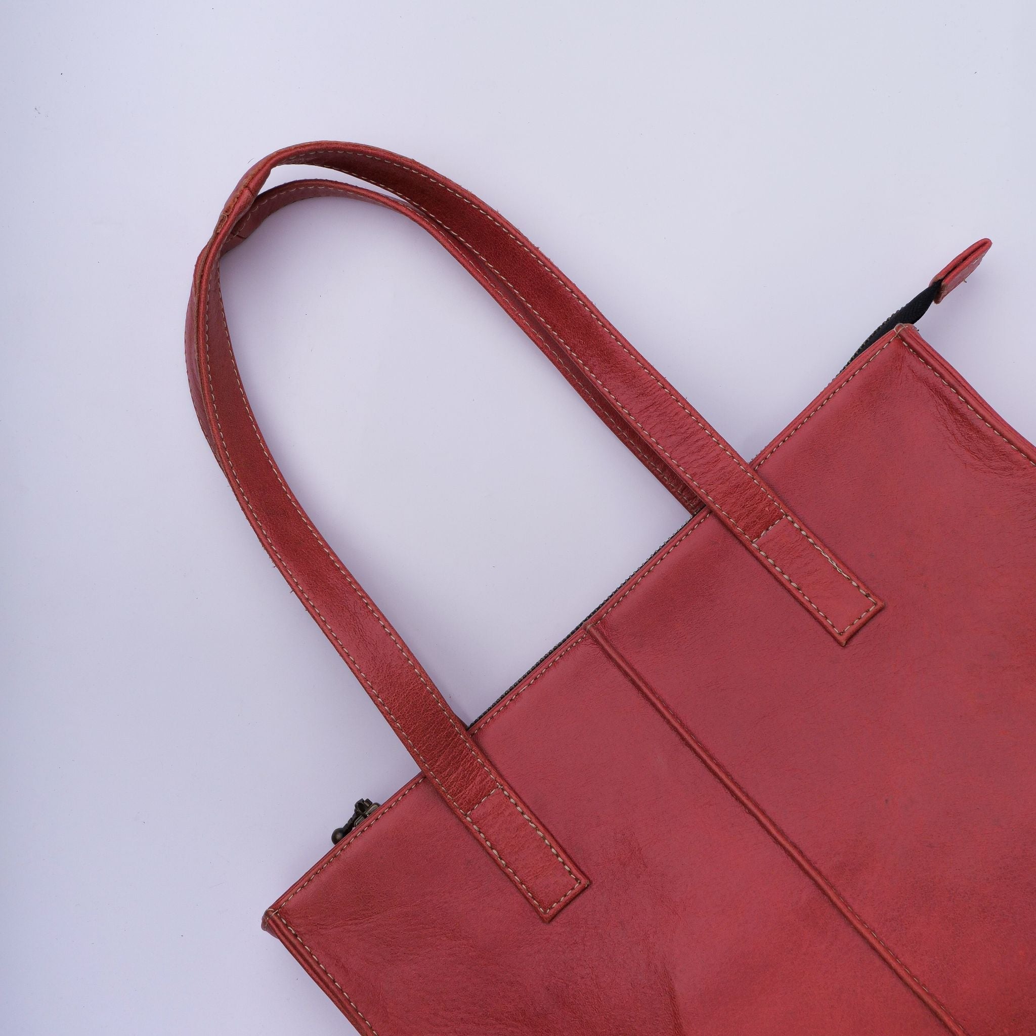 Everyday Women's Leather Zipper Tote Bag in Candy Red, showcasing its spacious design, premium cow leather material, and stylish hardware.
