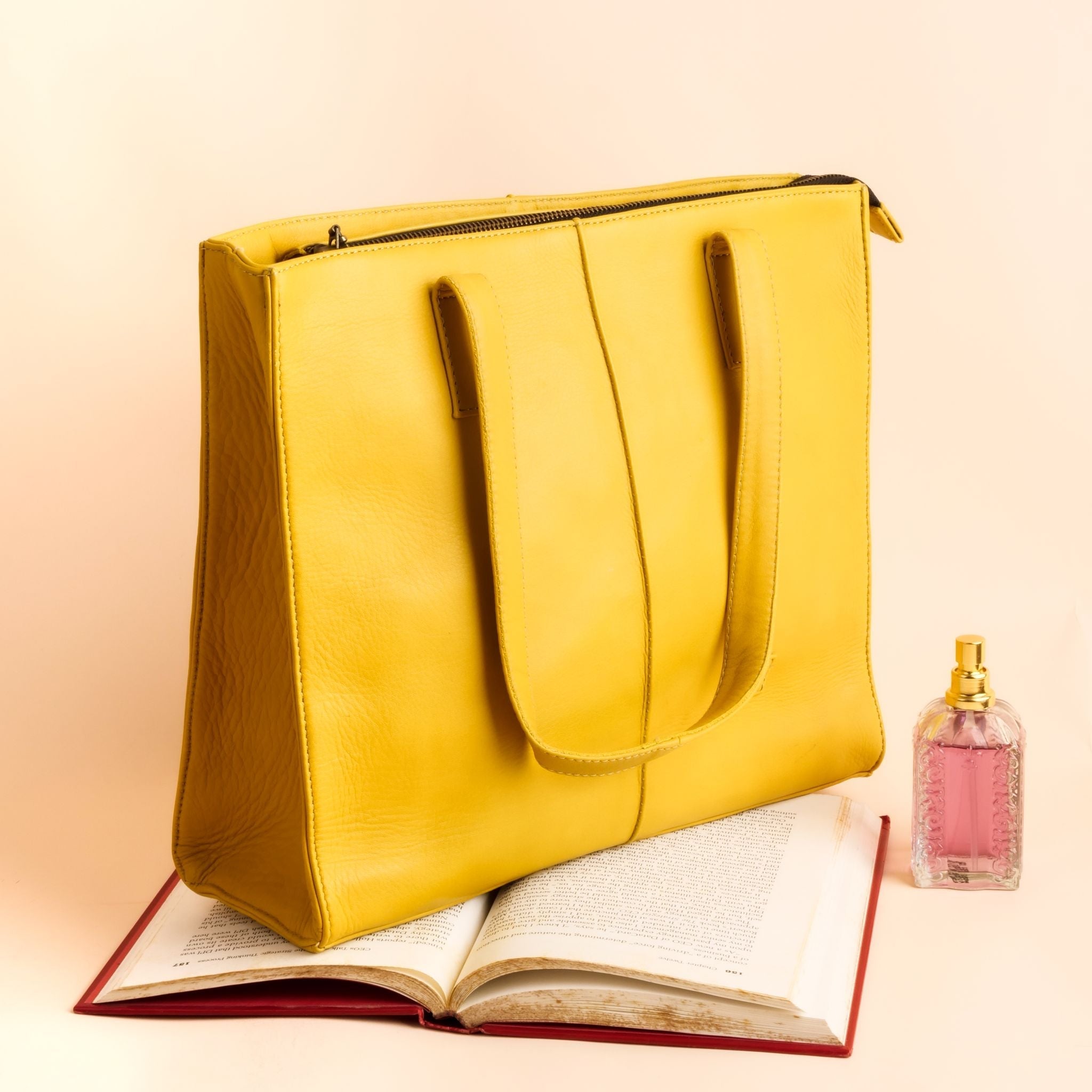 Everyday Women's Leather Zipper Tote Bag in Mustard Yellow, showcasing its spacious design and premium cow leather material.