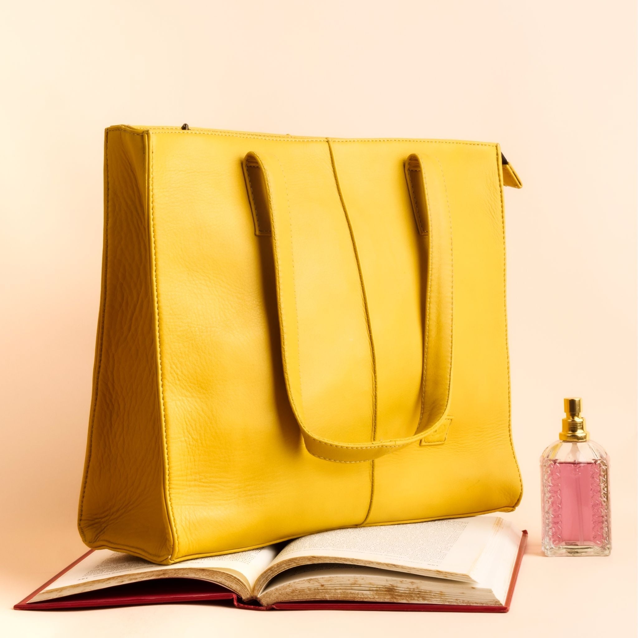 Everyday Women's Leather Zipper Tote Bag in Mustard Yellow, showcasing its spacious design and premium cow leather material.