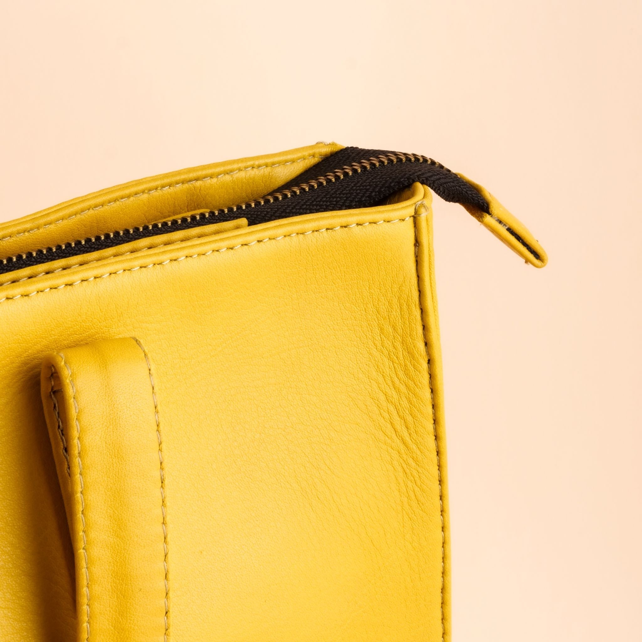 Everyday Women's Leather Zipper Tote Bag in Mustard Yellow, showcasing its spacious design and premium cow leather material.