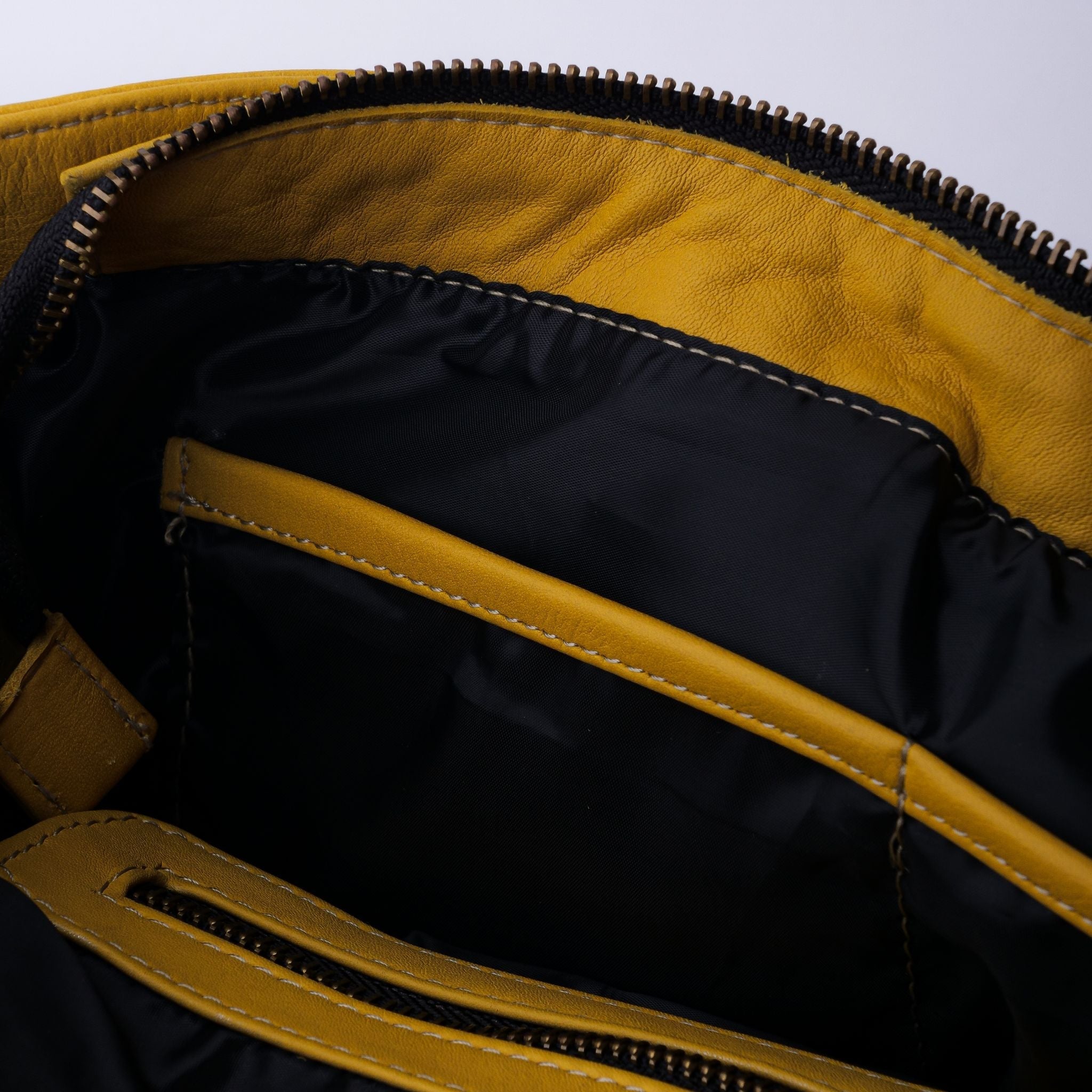 Everyday Women's Leather Zipper Tote Bag in Mustard Yellow, showcasing its spacious design and premium cow leather material.