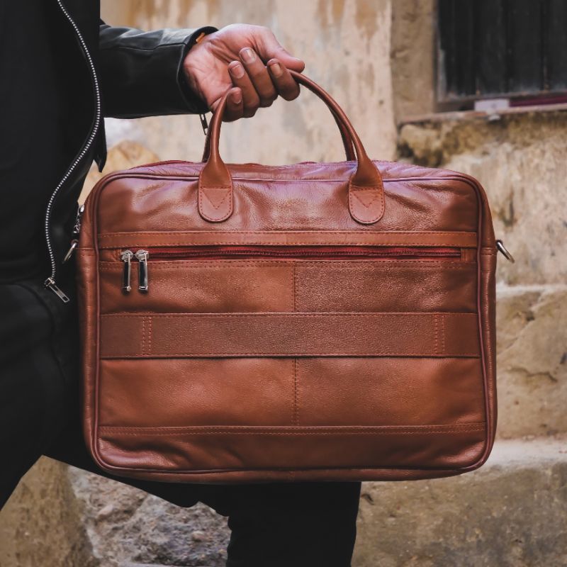 Executive Leather Laptop Bag in tan color, crafted from genuine cow leather, featuring adjustable shoulder strap and spacious compartments.