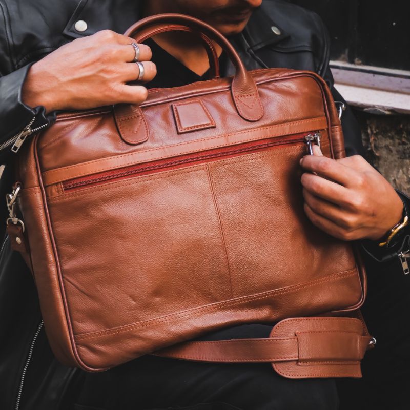 Executive Leather Laptop Bag in tan color, crafted from genuine cow leather, featuring adjustable shoulder strap and spacious compartments.