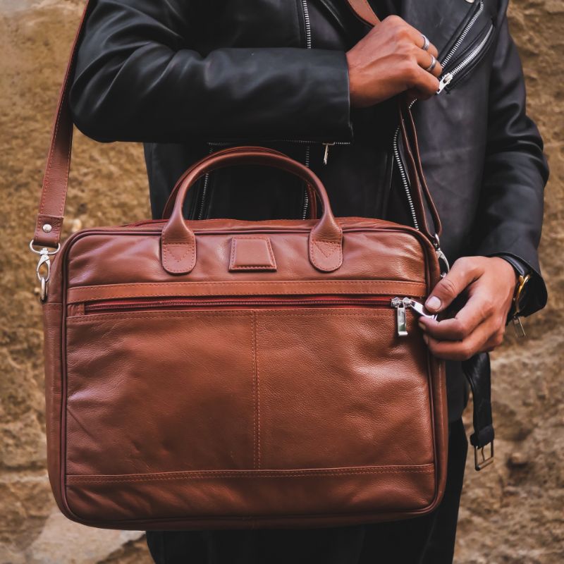 Executive Leather Laptop Bag in tan color, crafted from genuine cow leather, featuring adjustable shoulder strap and spacious compartments.