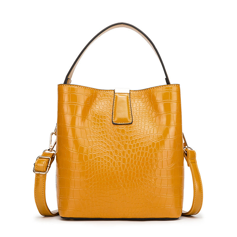 Fashionable Retro Bucket Style Handbag for Women in super oil leather with stone pattern, featuring multiple pockets and a stylish design.
