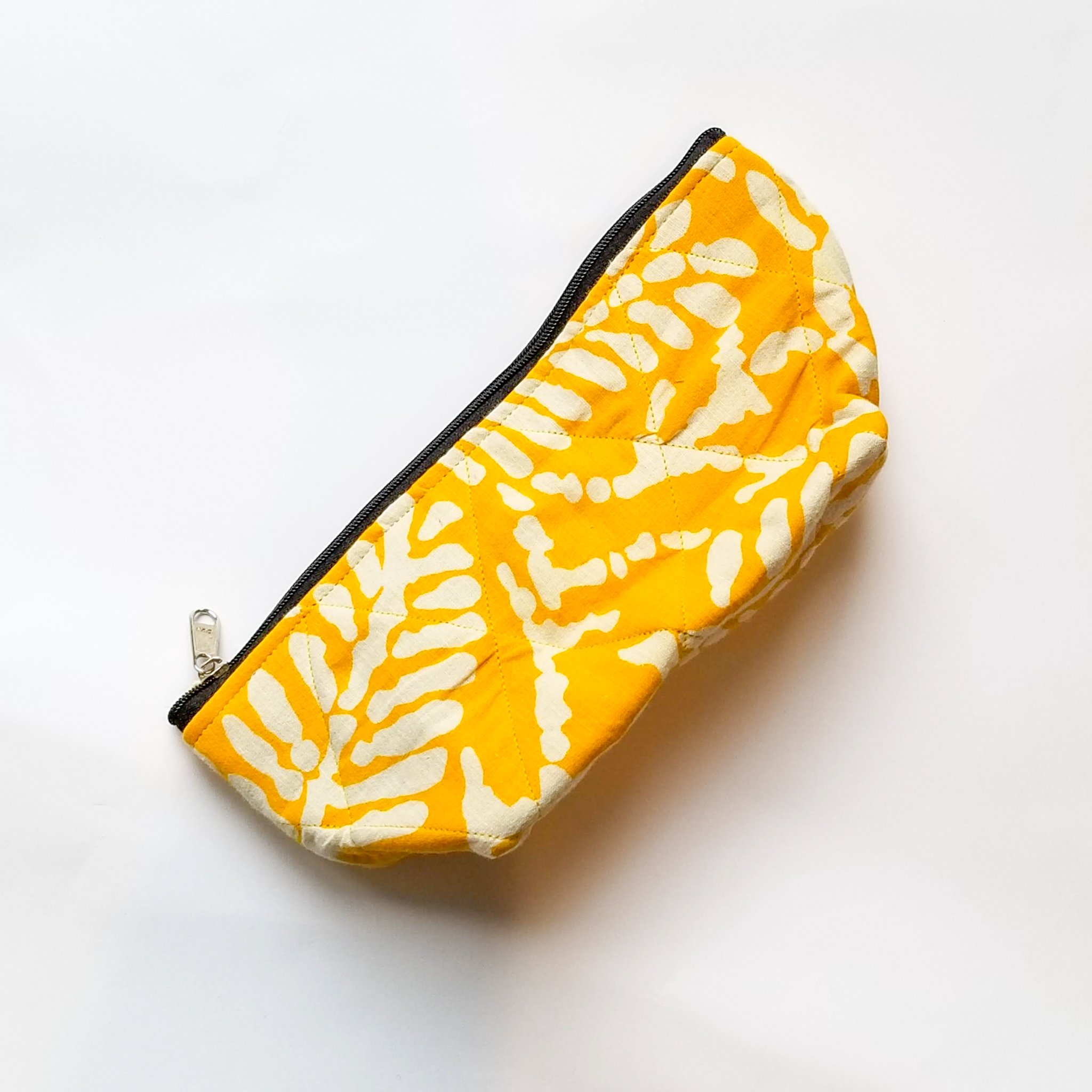Flat sari zip pouch featuring unique patchwork design, handcrafted by artisans in Pondicherry, India, showcasing vibrant colors and intricate patterns.