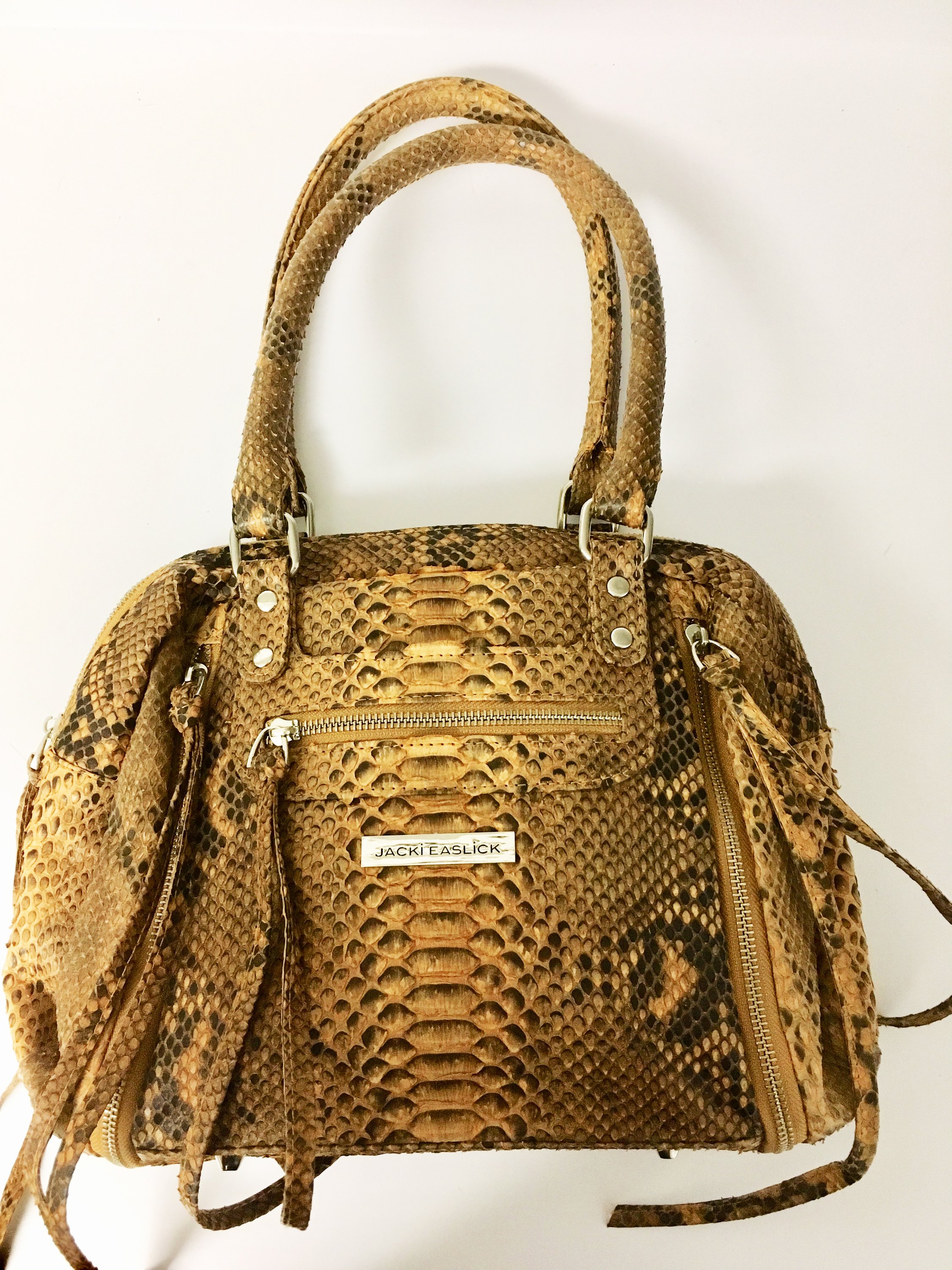 Gold Real Python Satchel featuring expanding zippers, showcasing its unique design and luxurious texture.