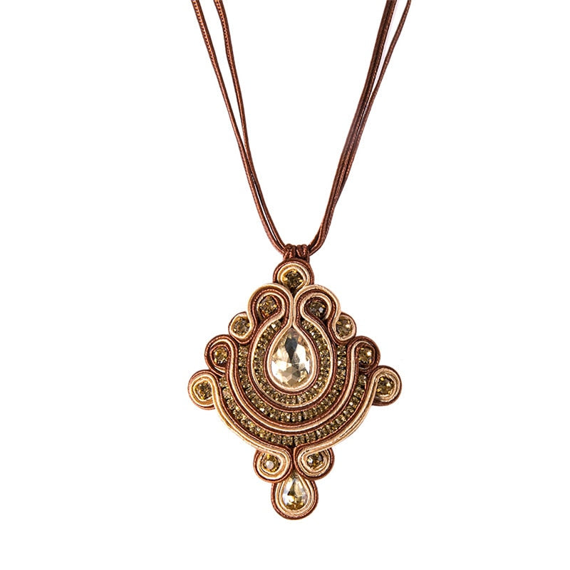 A beautifully crafted Handmade Soutache Necklace featuring intricate soutache patterns in pink, blue, and brown colors, adorned with sparkling rhinestones.