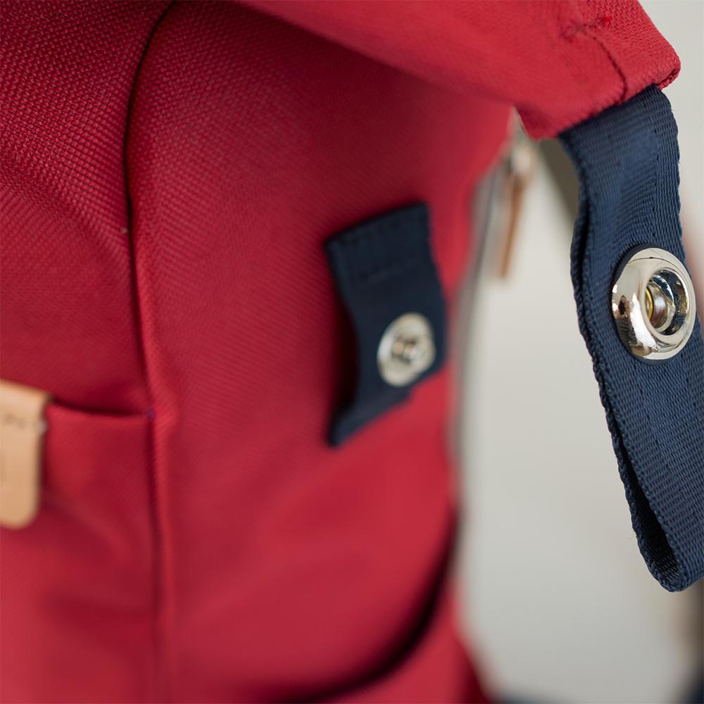 Highline Daypack in various colors with leather accents, showcasing its sleek design and multiple pockets.