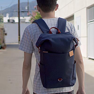 Highline Daypack in various colors with leather accents, showcasing its sleek design and multiple pockets.
