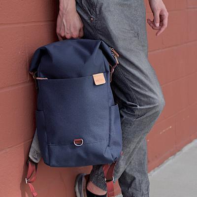Highline Daypack in various colors with leather accents, showcasing its sleek design and multiple pockets.