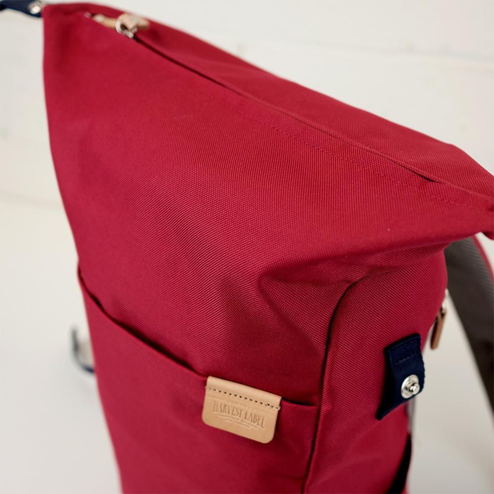 Highline Daypack in various colors with leather accents, showcasing its sleek design and multiple pockets.