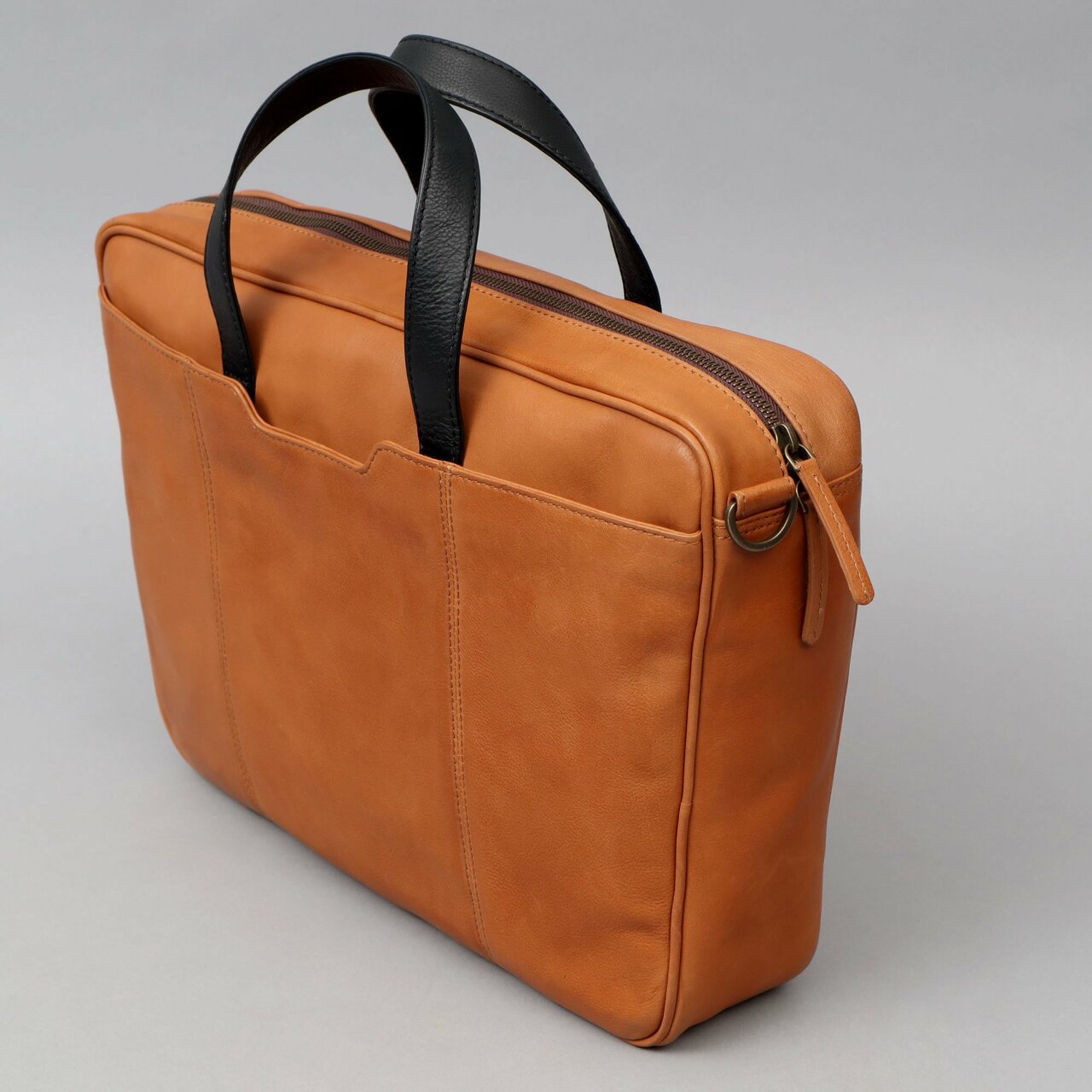 Hogan Leather Briefcase made from premium full grain leather, featuring multiple pockets and a padded laptop compartment, showcasing its elegant design.