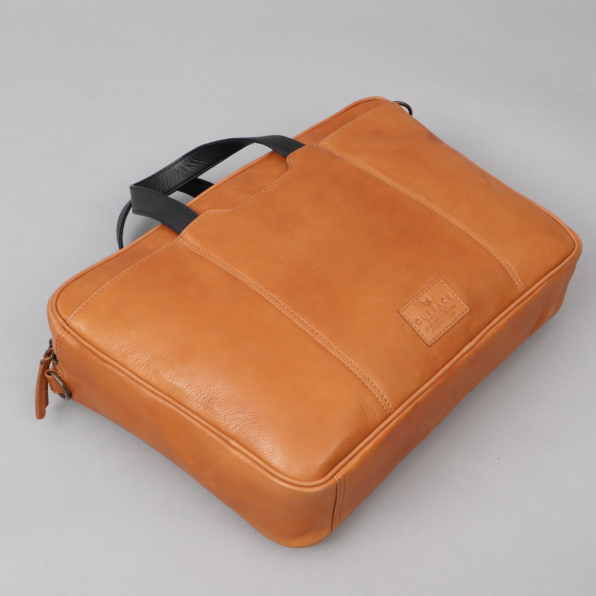 Hogan Leather Briefcase made from premium full grain leather, featuring multiple pockets and a padded laptop compartment, showcasing its elegant design.