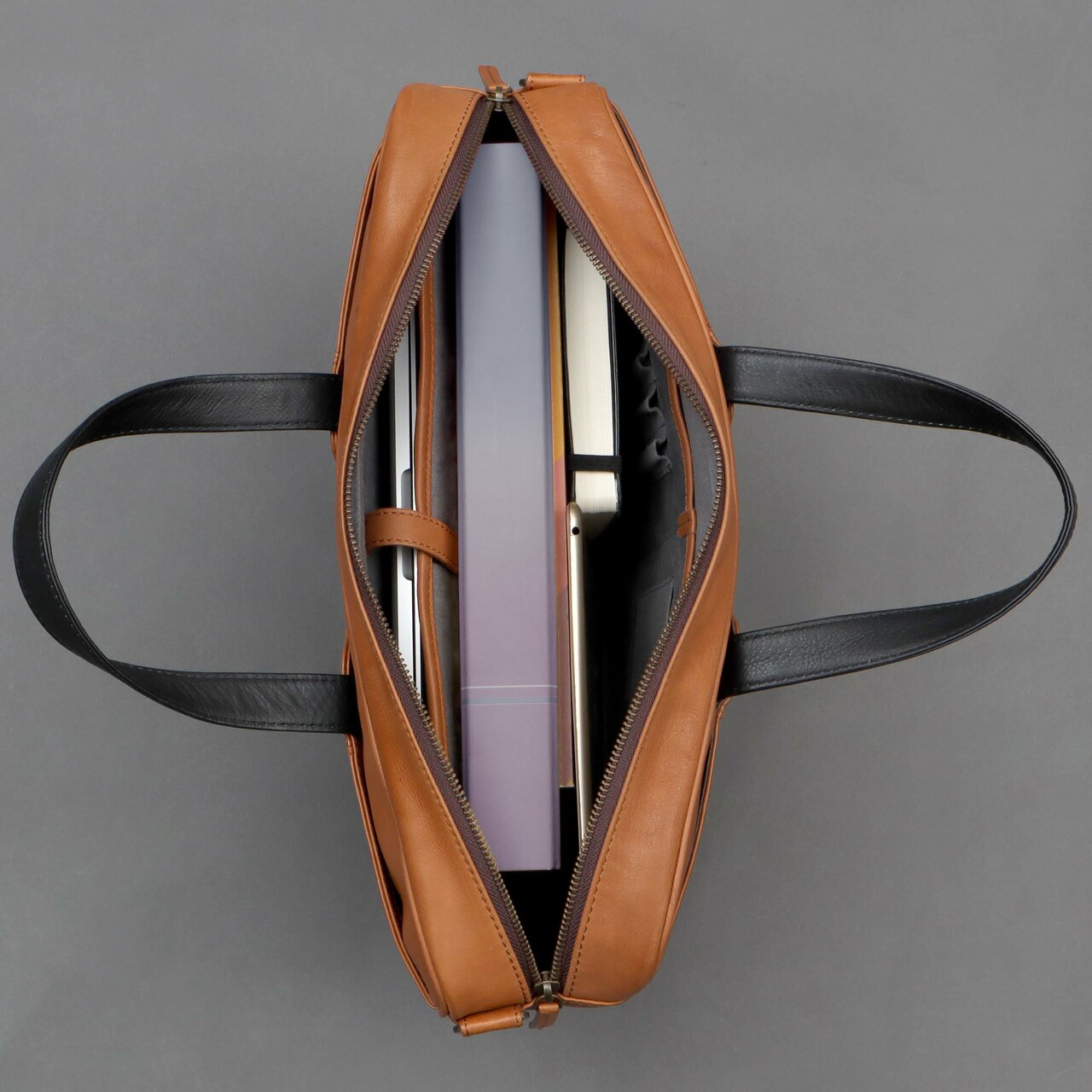 Hogan Leather Briefcase made from premium full grain leather, featuring multiple pockets and a padded laptop compartment, showcasing its elegant design.