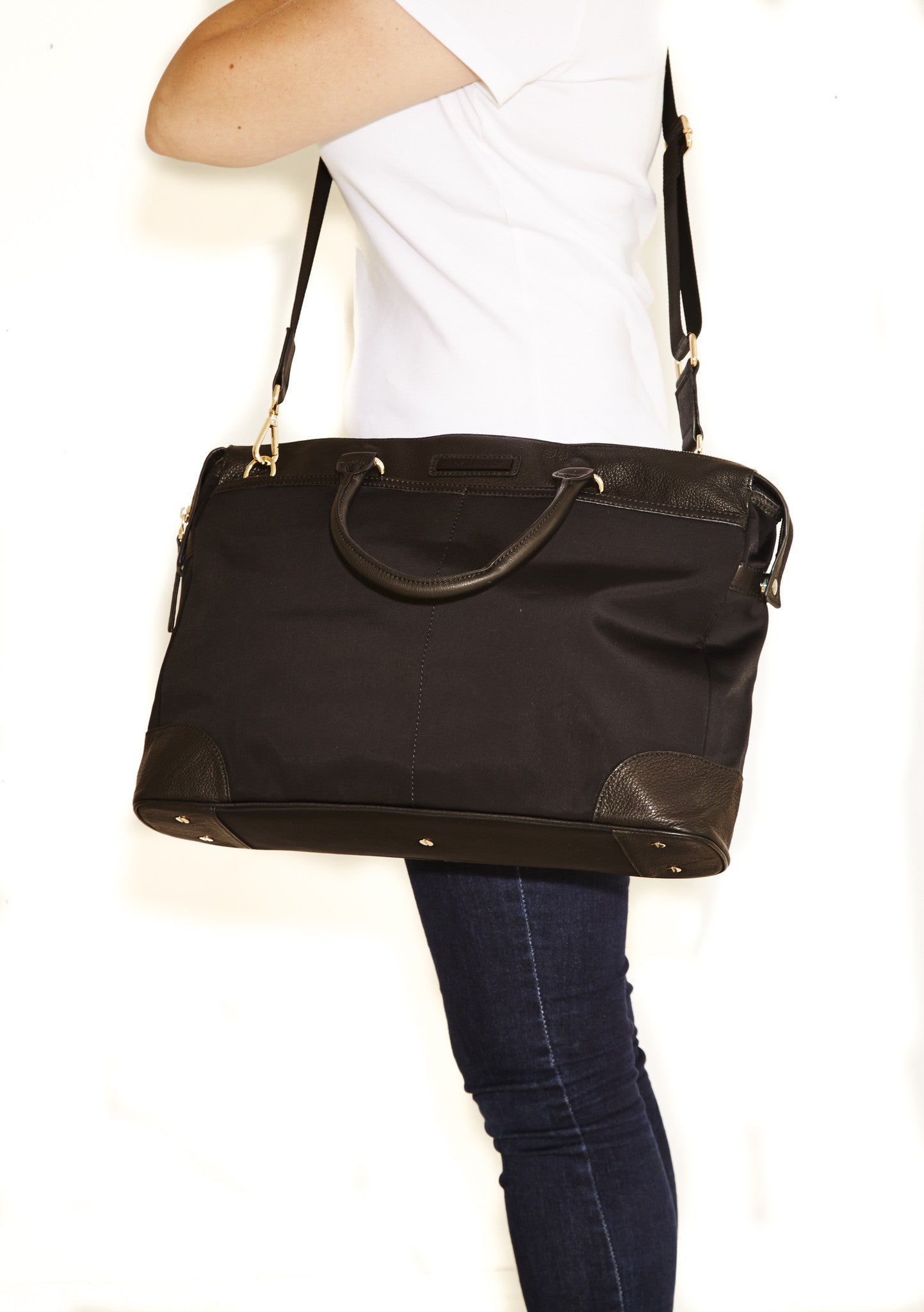 Jacki Easlick Black nylon briefcase featuring cowhide leather trim, waterproof material, and multiple pockets for organization.
