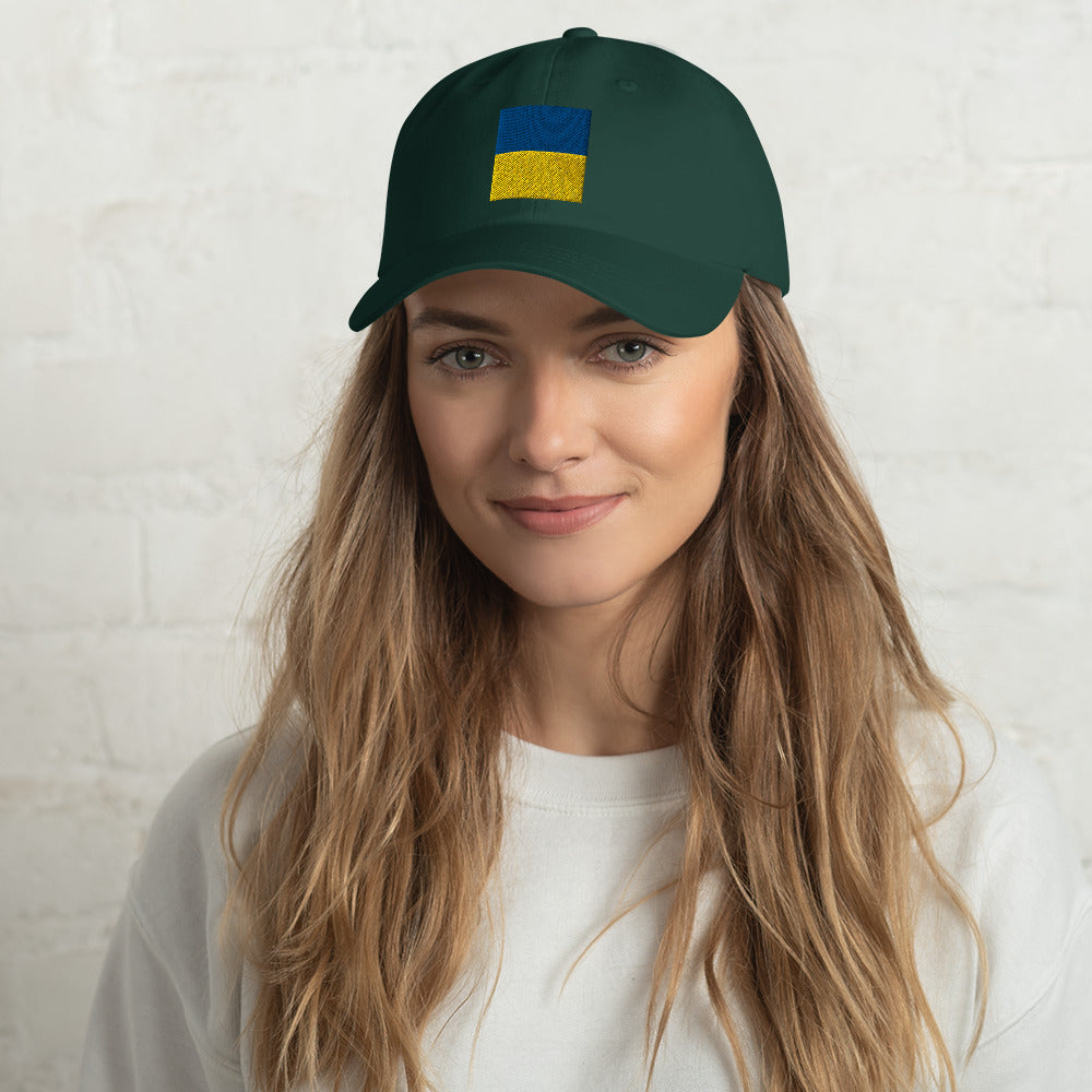 Jacki Easlick Support Ukraine Hat featuring green camo design, embroidered details, and adjustable strap.