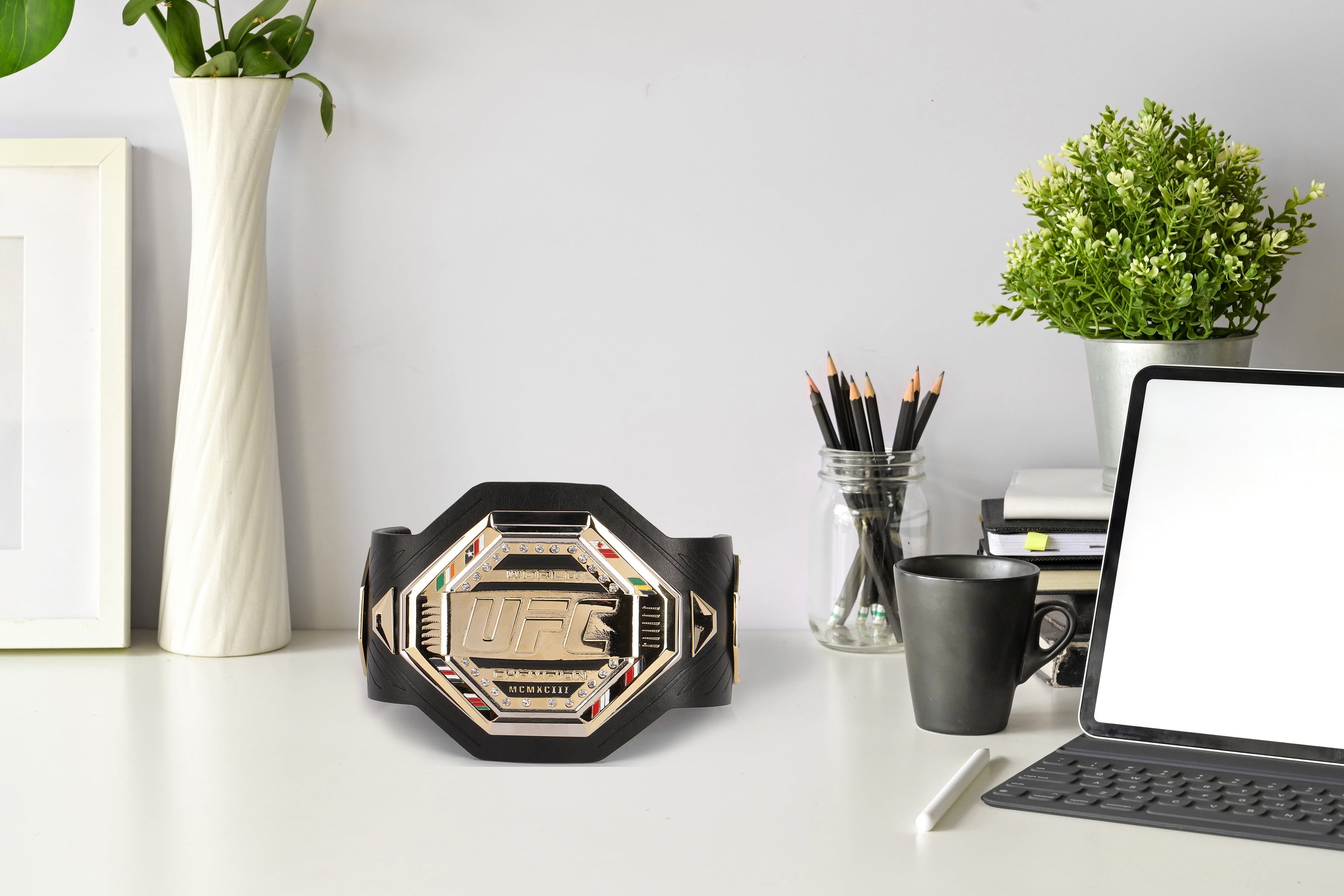 Jiří Procházka signed UFC legacy replica desktop belt displayed on a desk, showcasing its intricate design and signature.