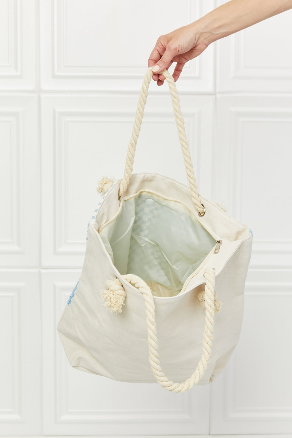 Justin Taylor Picnic Date Tassle Tote Bag featuring a plaid pattern and sturdy rope handles, ideal for beach and park outings.
