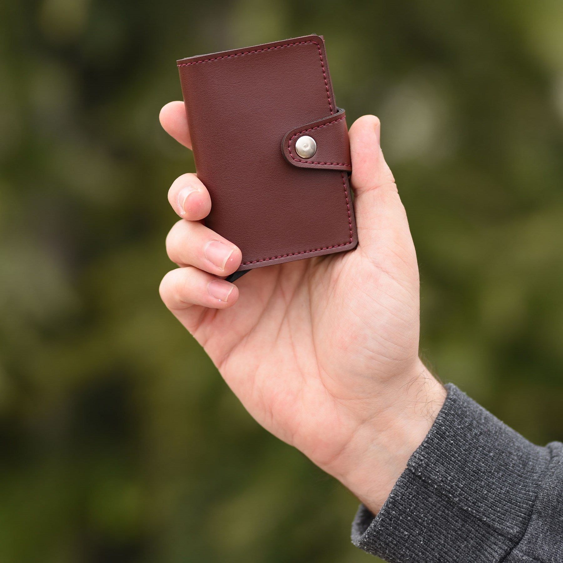Konk Synthetic Leather RFID Protection Pop-up Cardholder in red, showcasing its sleek design and pop-up mechanism.