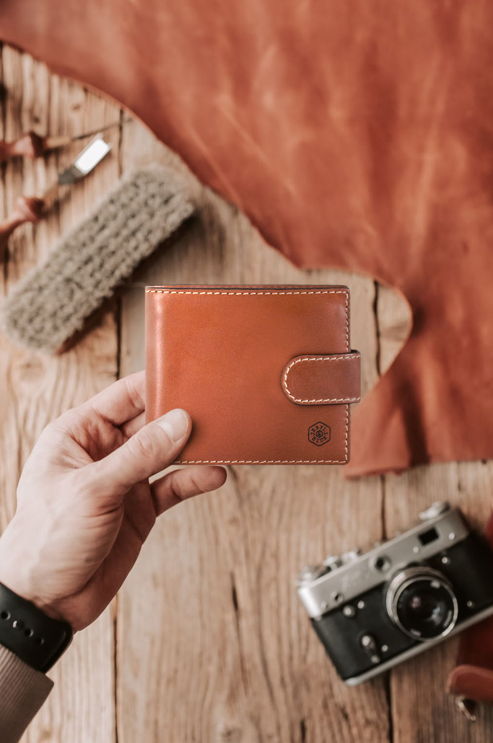 Large bifold wallet in clay color with a coin pouch, showcasing double-edged stitching and spacious design.