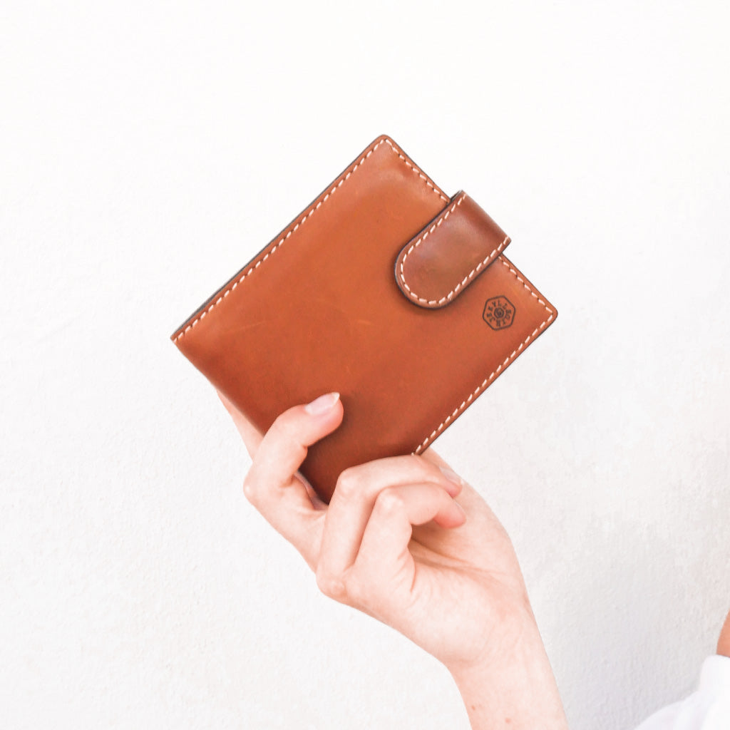 Large bifold wallet in clay color with a coin pouch, showcasing double-edged stitching and spacious design.