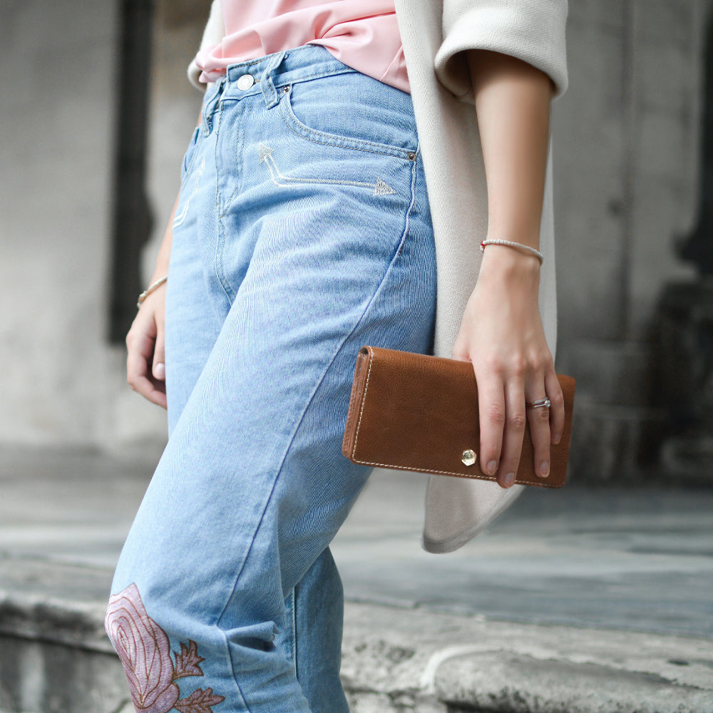 Large tan leather purse with multiple compartments, ideal for organizing cards and personal items.