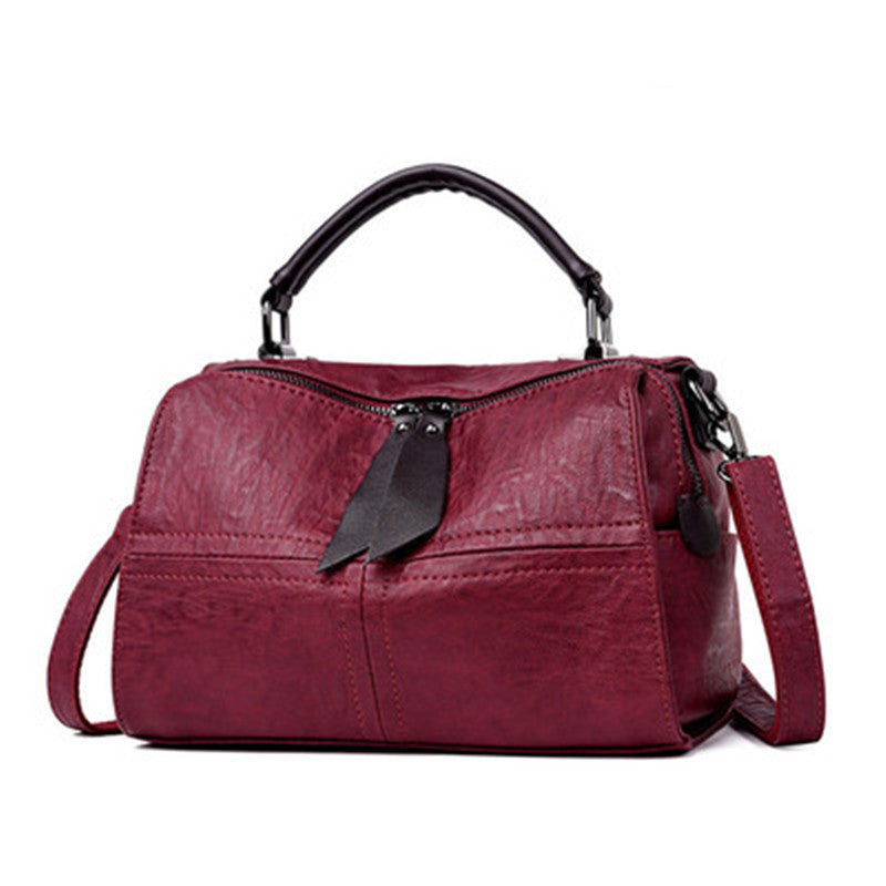 Large-capacity Boston Style Soft Leather Messenger Bag in plain design, showcasing its spacious interior and soft leather material.