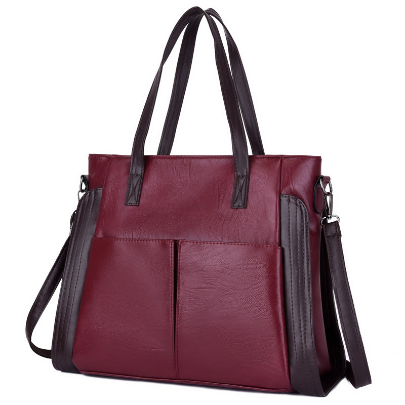 Large-capacity soft leather single-shoulder messenger bag in a stylish tote design, featuring a zipper closure and multiple internal pockets.