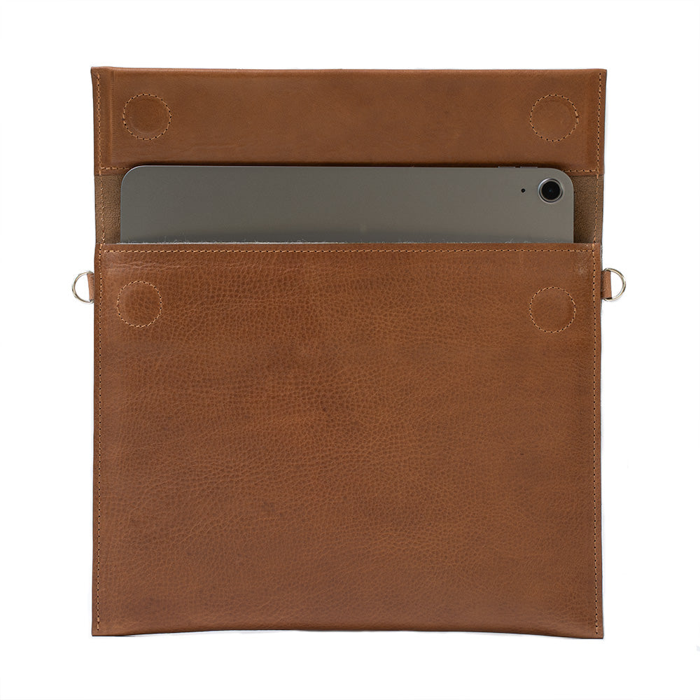 Elegant leather bag designed for iPad, featuring adjustable strap and magnetic closure, showcasing premium craftsmanship.