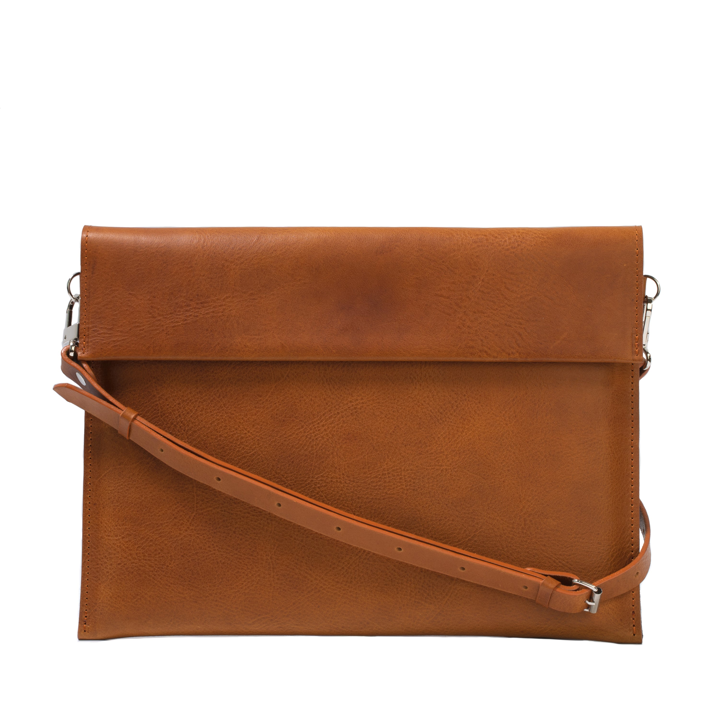 Elegant leather bag designed for iPad, featuring adjustable strap and magnetic closure, showcasing premium craftsmanship.