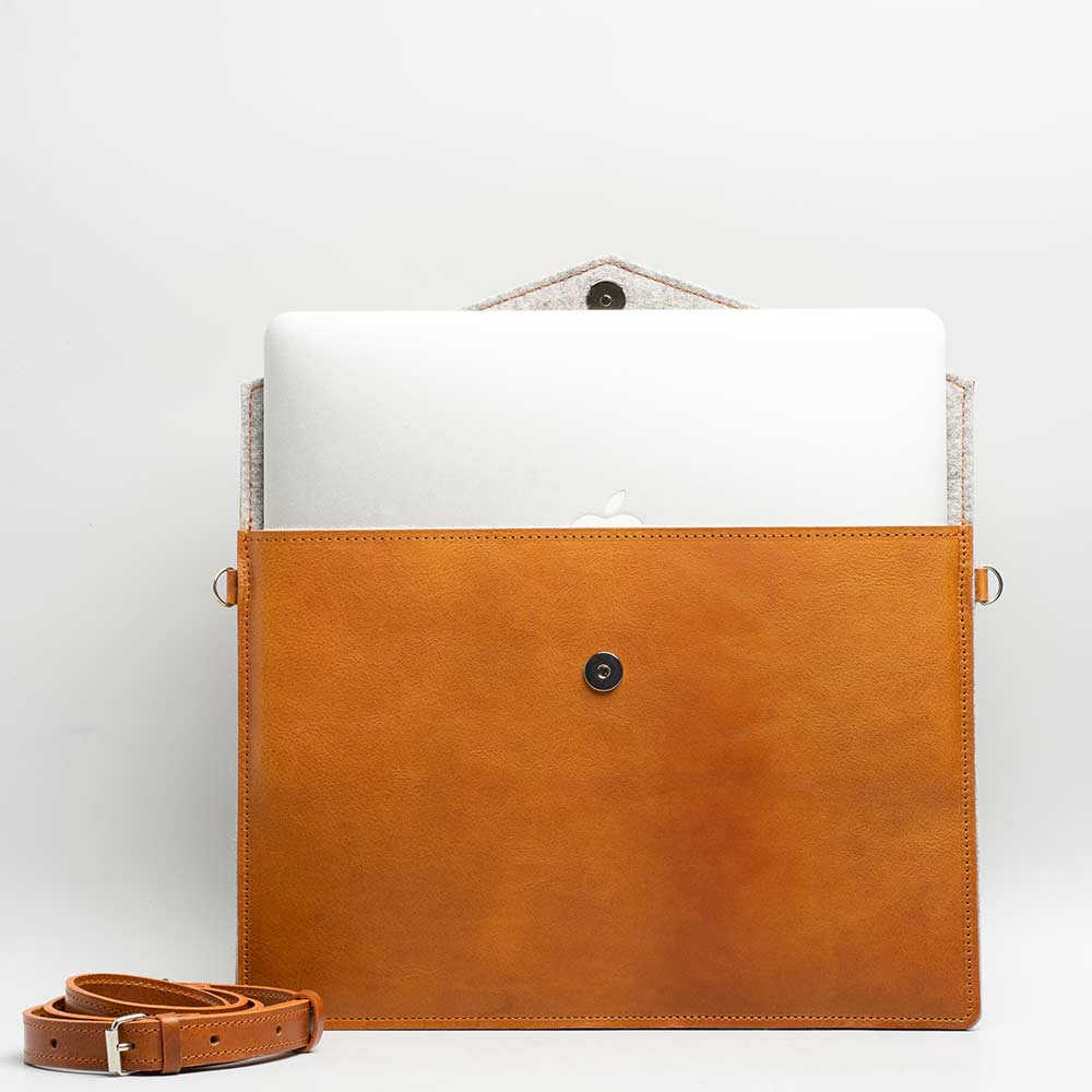 Premium leather bag for iPad with adjustable strap, showcasing its elegant design and wool felt lining.