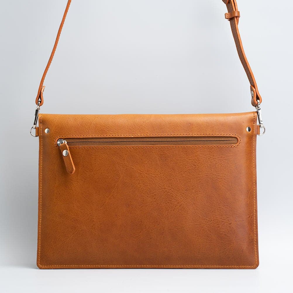 Premium leather bag for iPad with adjustable strap, showcasing its elegant design and wool felt lining.