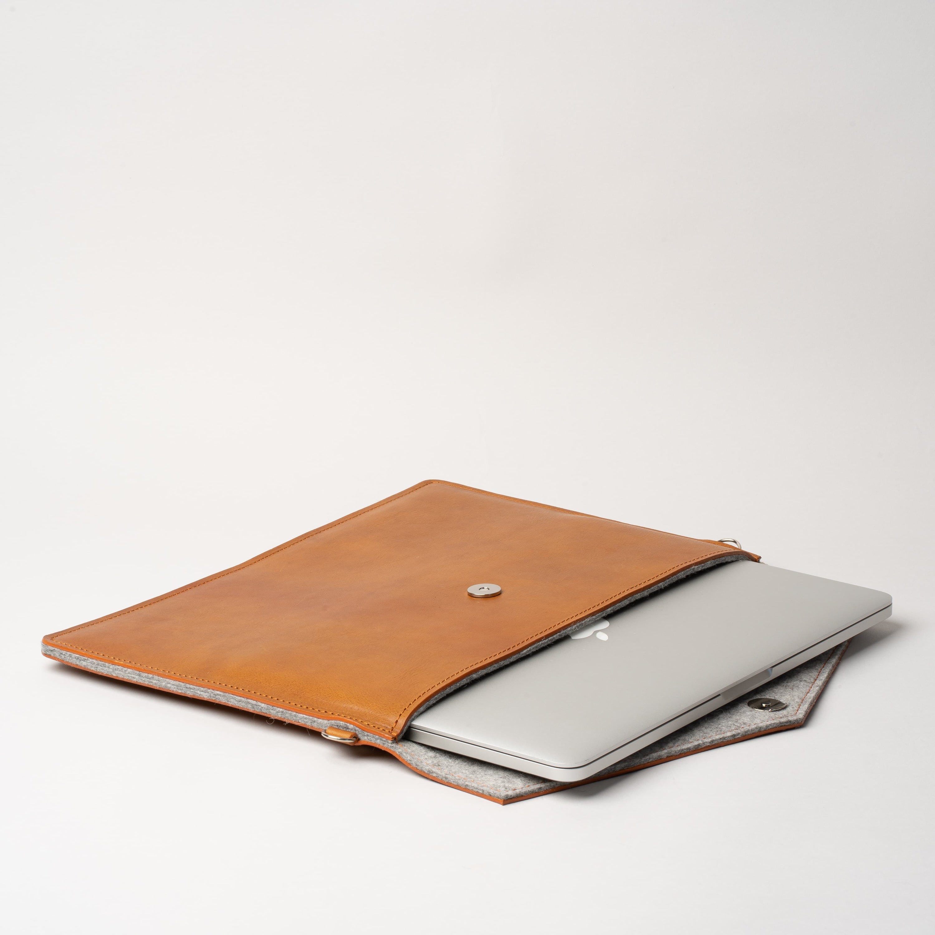 Premium leather bag for iPad with adjustable strap, showcasing its elegant design and wool felt lining.