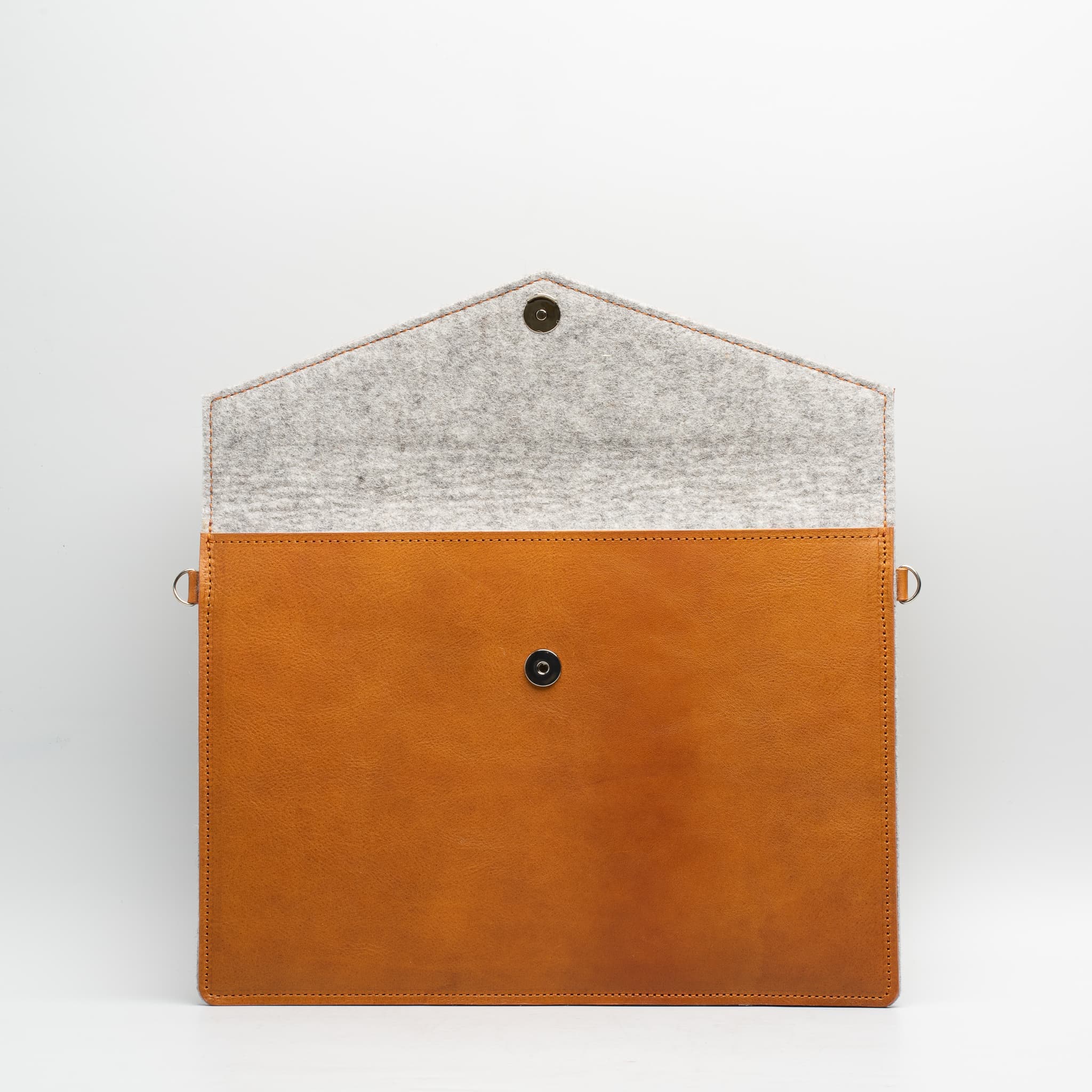 Premium leather bag for iPad with adjustable strap, showcasing its elegant design and wool felt lining.