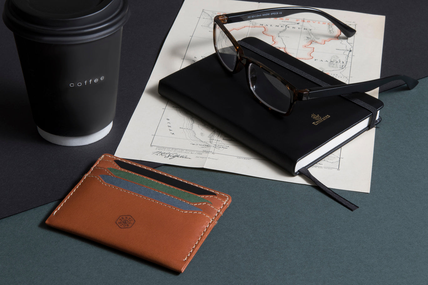 Tan leather card holder with multiple slots for cards and cash, showcasing a minimalist design.