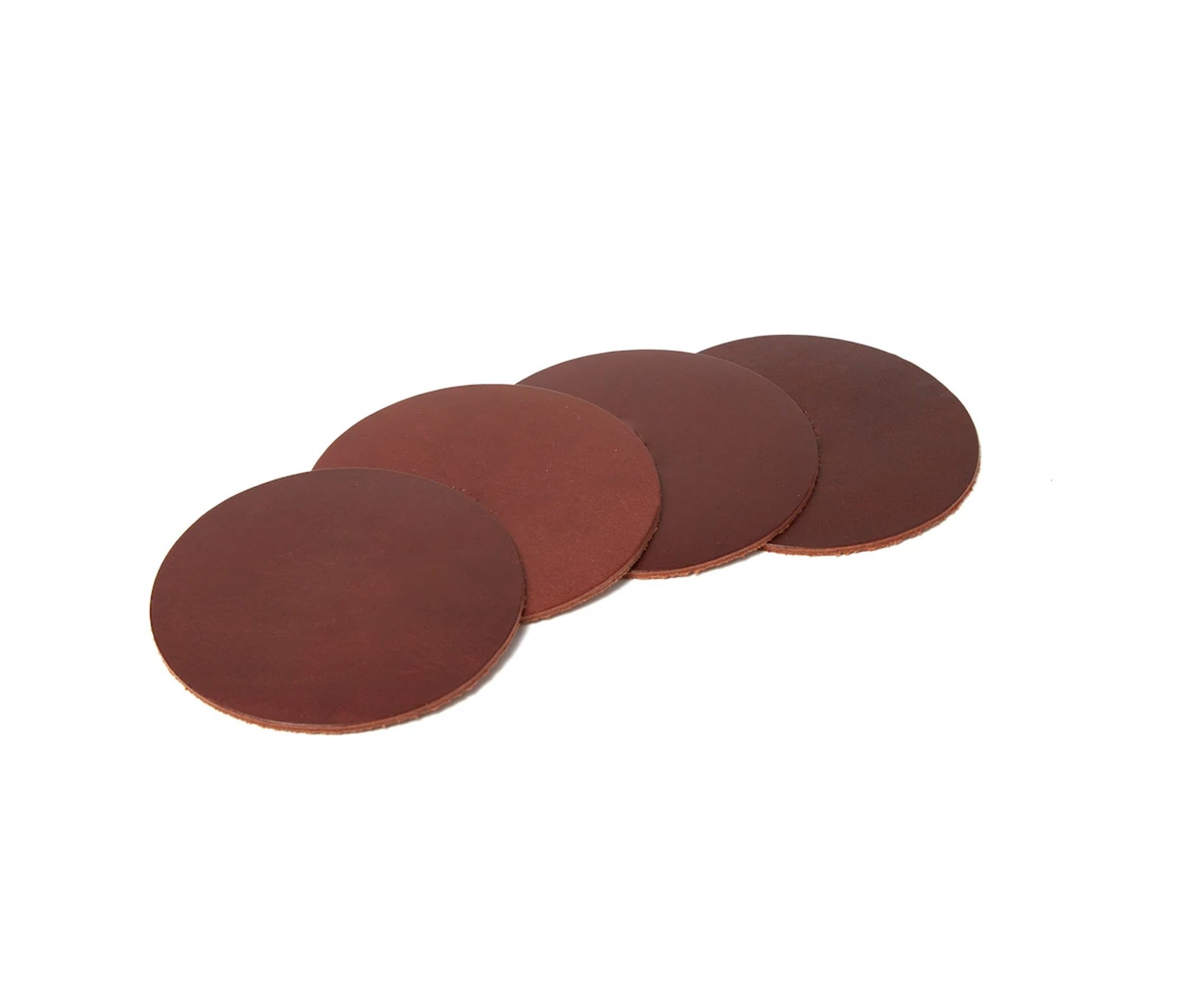 Set of four genuine leather coasters with custom branding options, elegantly displayed in a muslin duster bag.