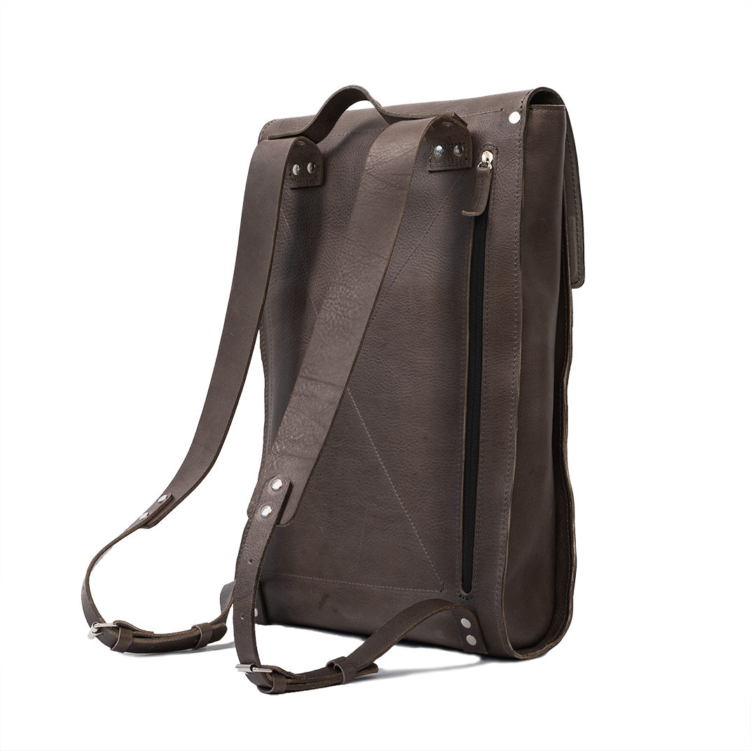 Gray leather laptop backpack with adjustable straps and multiple pockets, showcasing its minimalist design and eco-friendly materials.