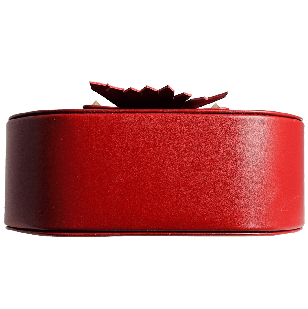 A stylish red leather saddle bag with dovetail fringe clasp, showcasing its luxurious design and spacious interior.