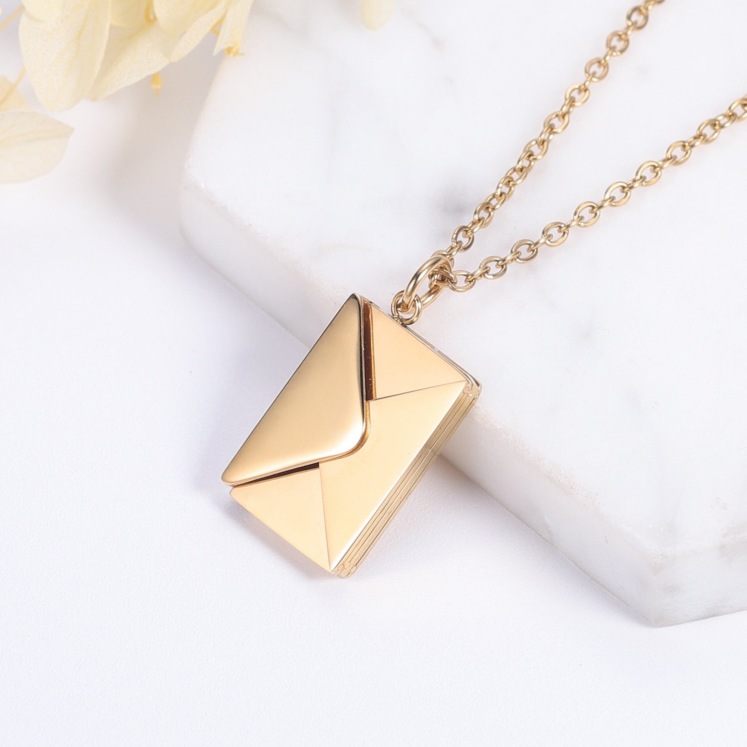 A beautiful Love Letter Envelope Pendant Necklace in gold, featuring customizable name engraving, elegantly displayed in a gift box.
