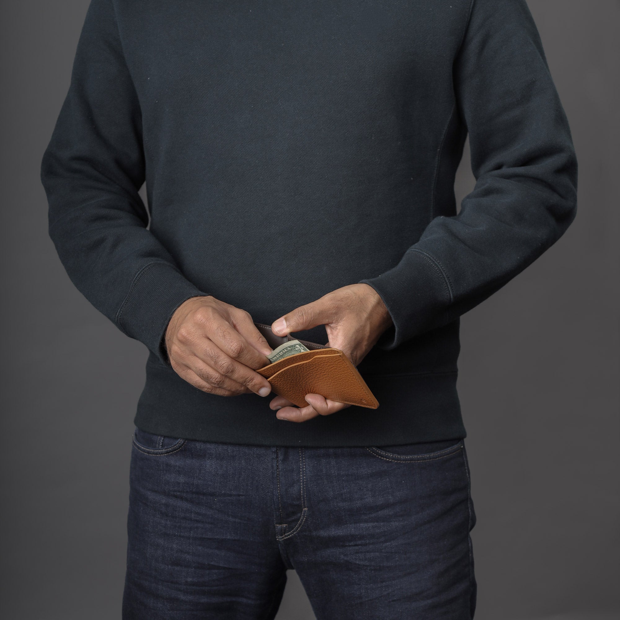 Max Wallet made from premium full grain leather with multiple pockets for cards and cash, featuring antique brass hardware and YKK zippers.