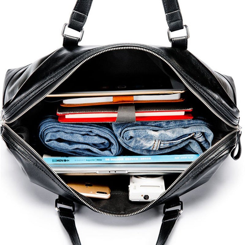 Men's waterproof leather travel bag in black, featuring multiple compartments and pockets for organization, ideal for business trips.