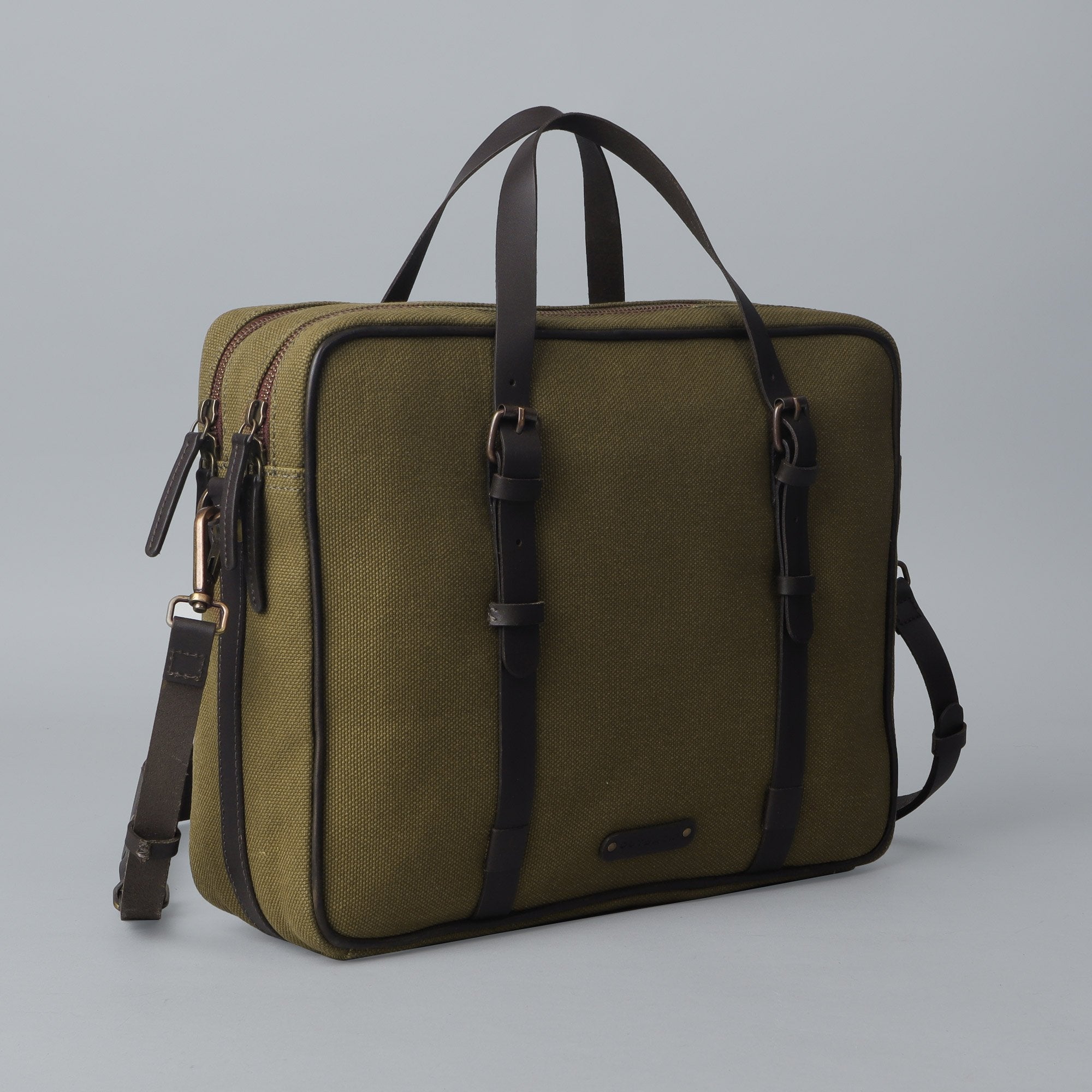 Miami Canvas Briefcase showcasing its spacious compartments and premium materials, featuring a sleek design with leather accents.